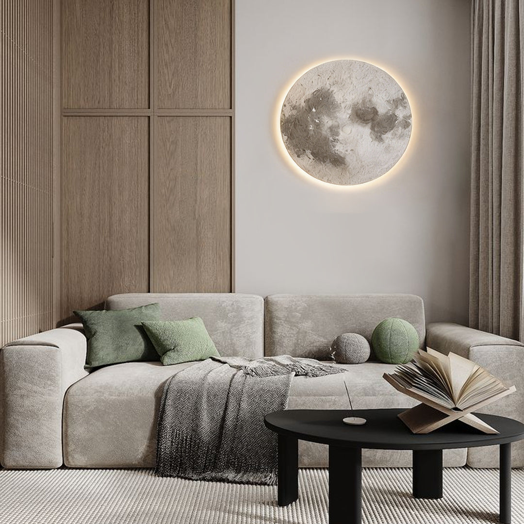 Moon wall lamp illuminating a cozy living room corner with warm, ambient glow.