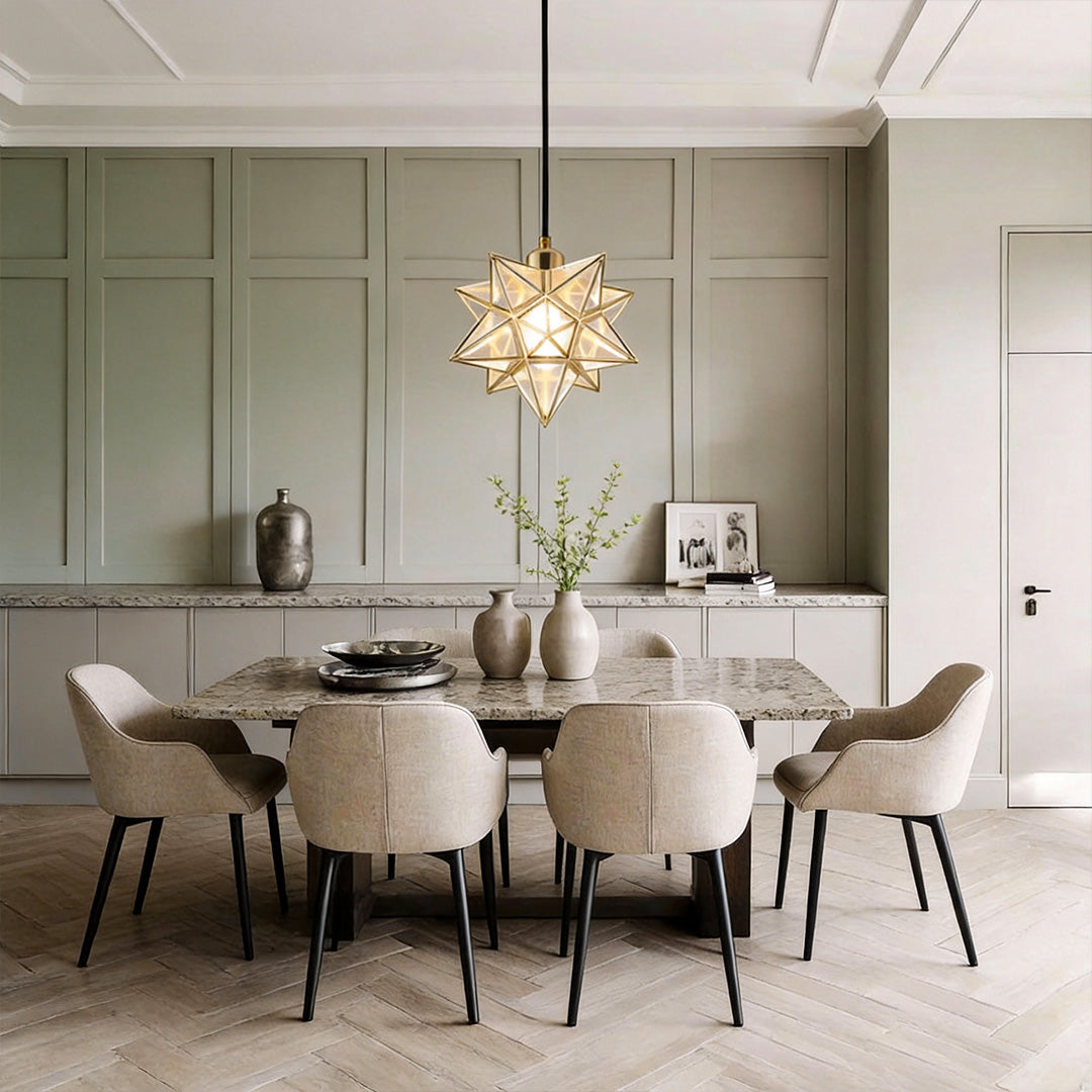 Elegant Moravian star pendant light hanging above a modern dining table with neutral decor.