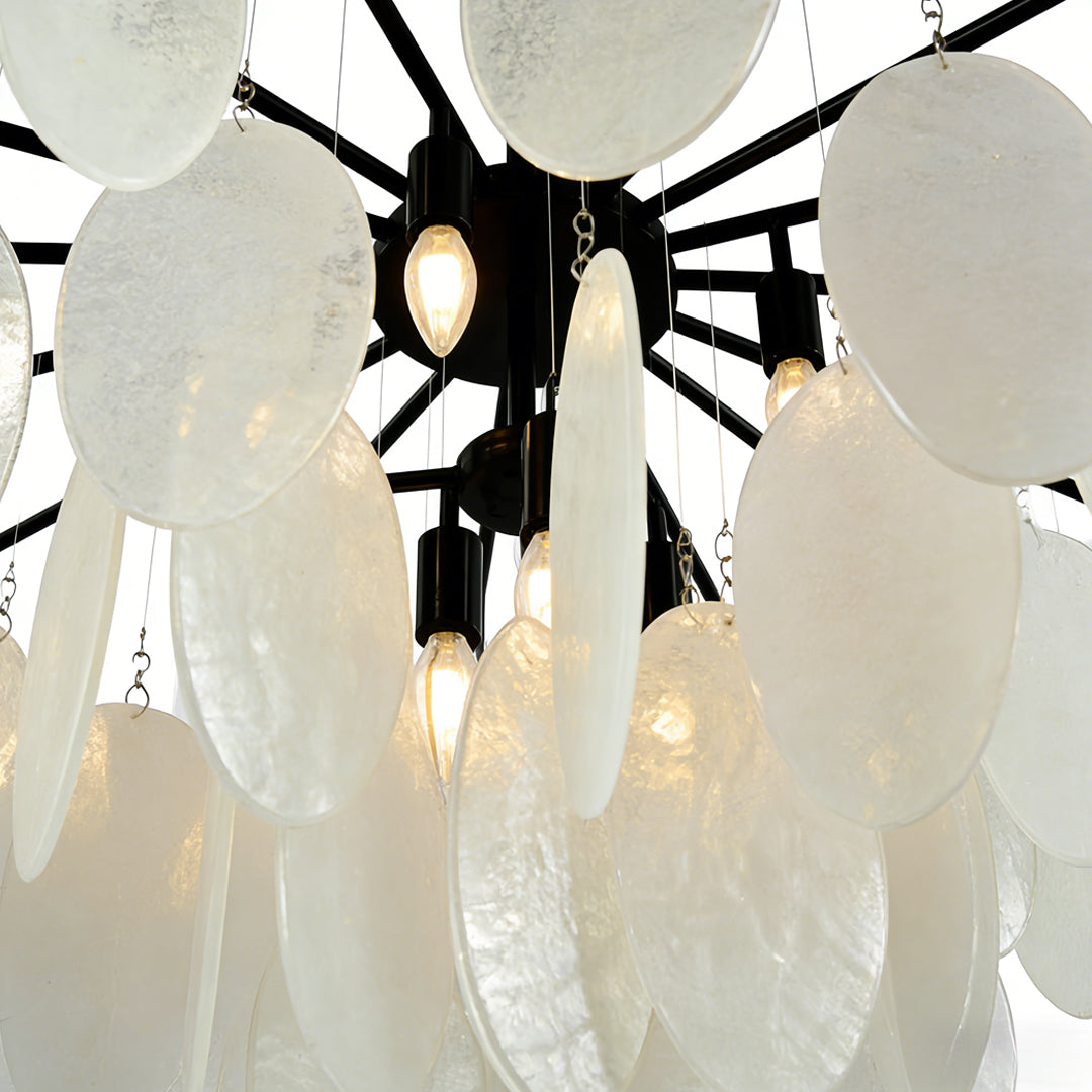 Mother of pearl chandelier with layered shell discs and warm glowing bulbs creating an elegant organic lighting design