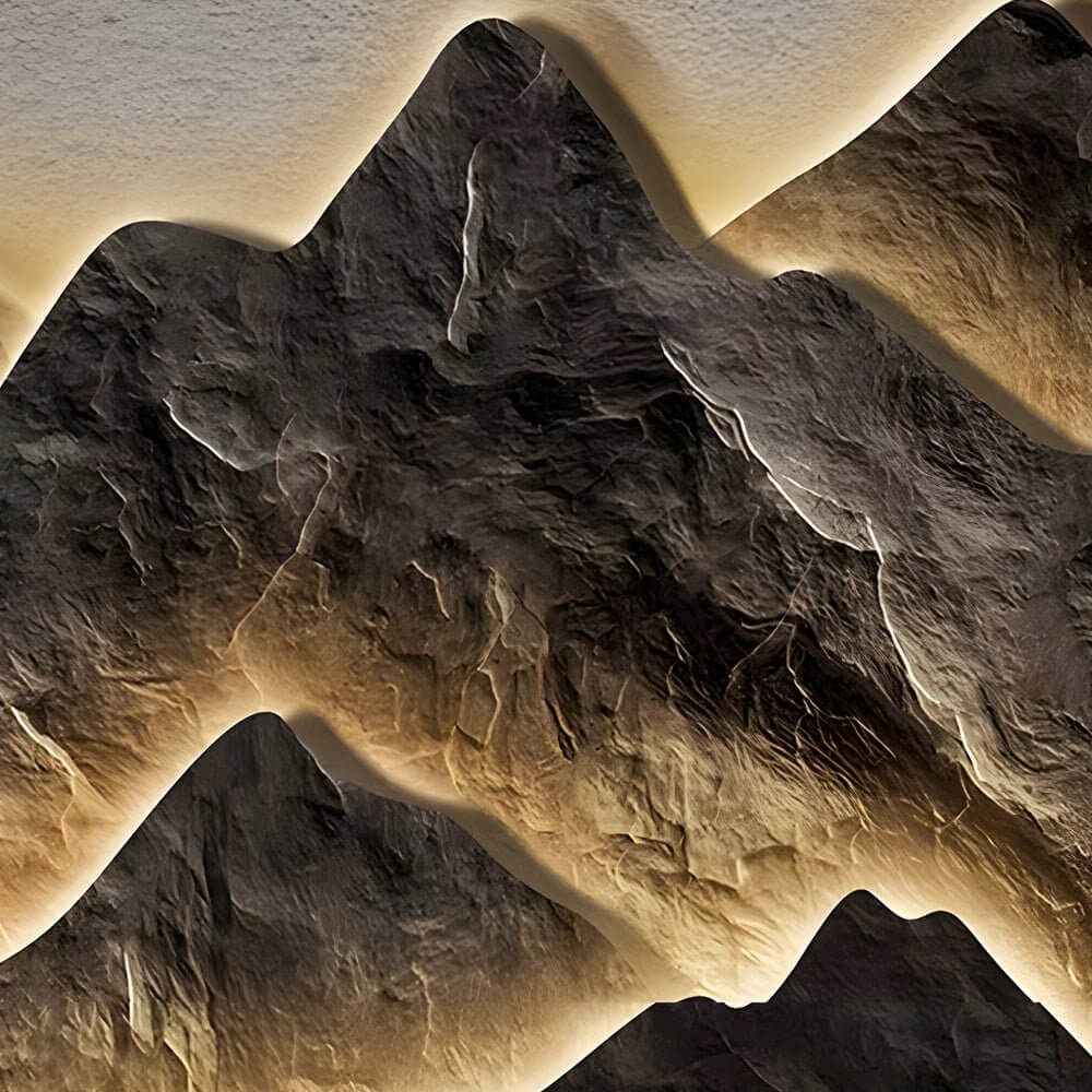 Mountain LED wall light showcasing its 3D mountain texture and warm light.