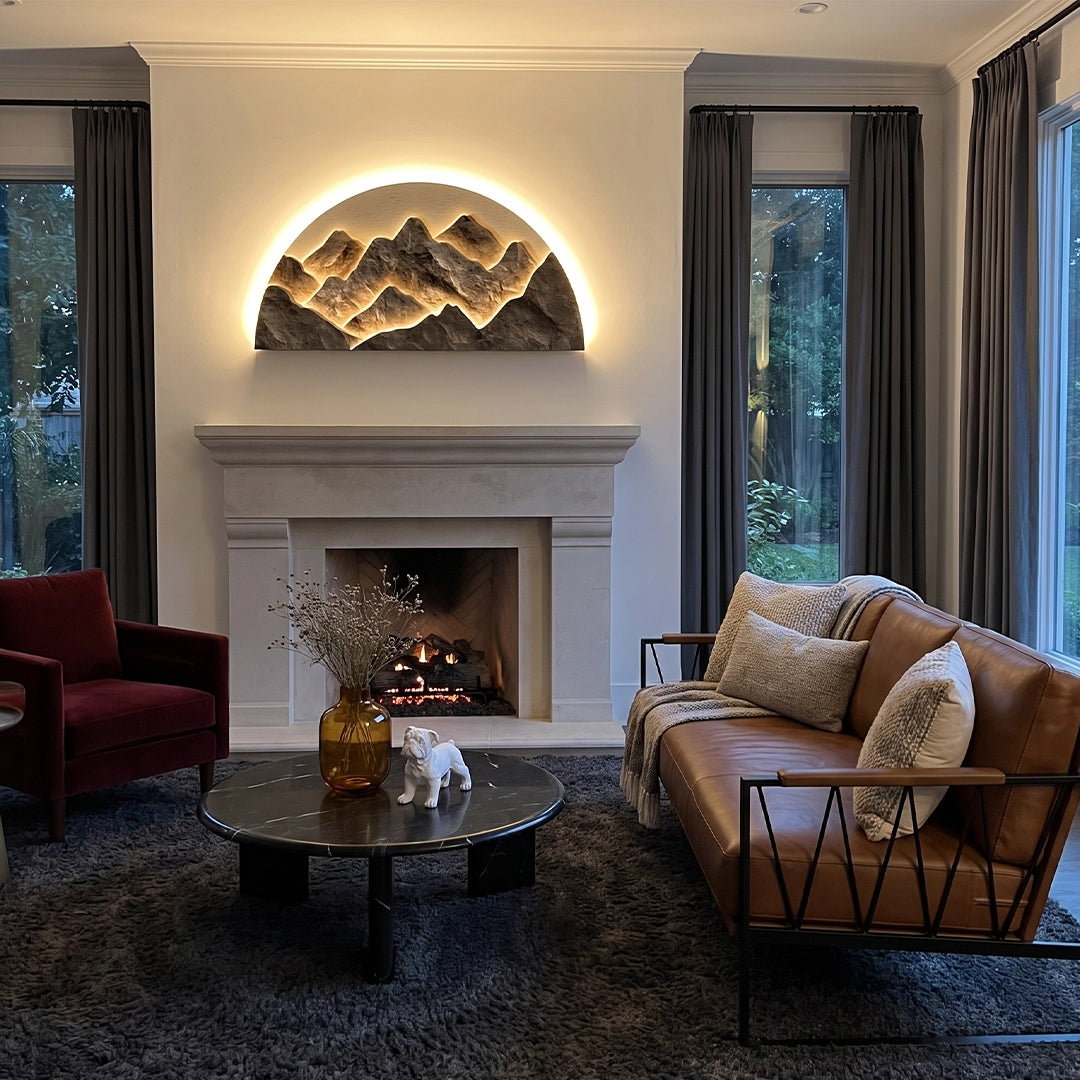 Mountain LED wall light mounted above a fireplace, glowing warmly in a modern living room.