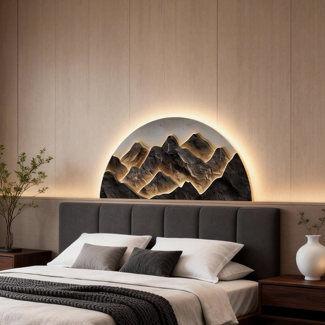 Mountain LED wall light adding a natural touch to a modern bedroom with a gray headboard.