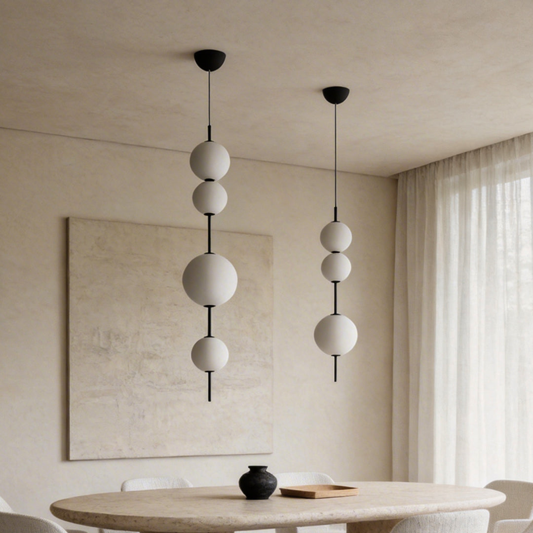 Multi ball pendant light providing ambient illumination in a contemporary living room.