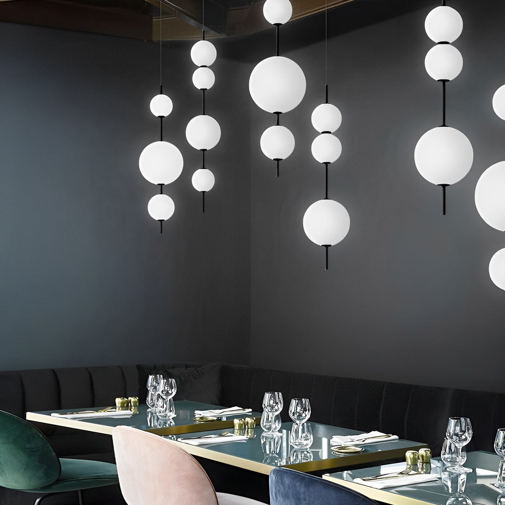 Multi ball pendant light with a minimalist design, installed in a modern kitchen.