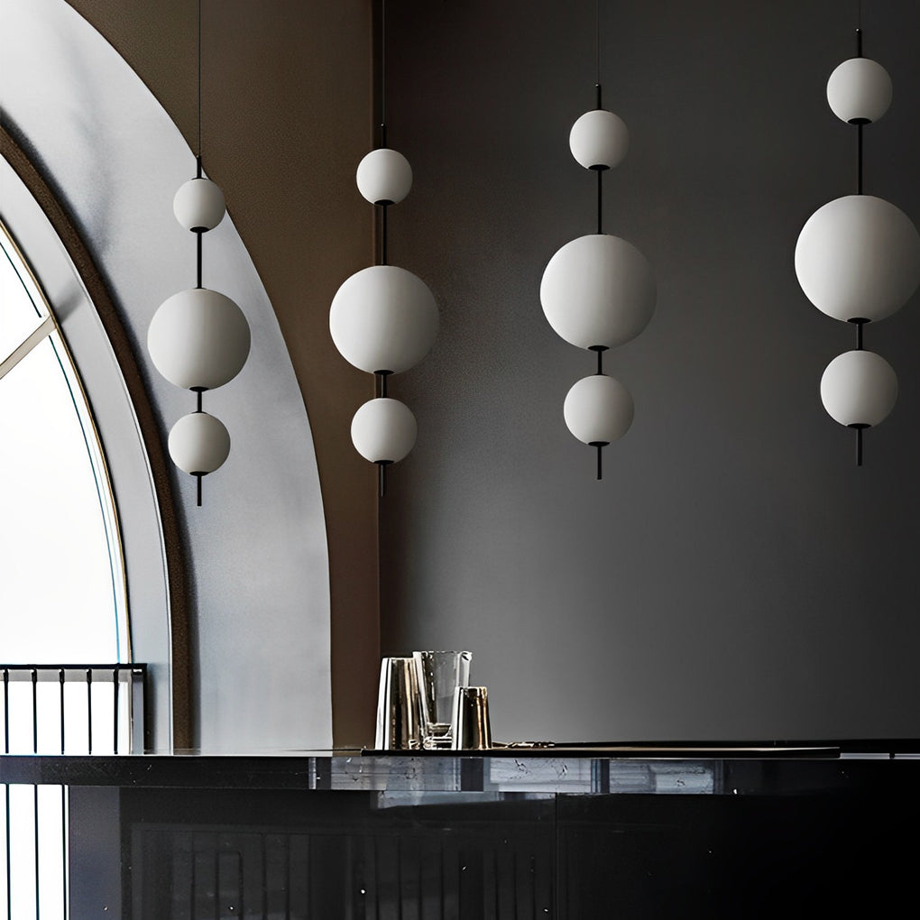 Multi ball pendant light with a modern design, hanging above a dining table.
