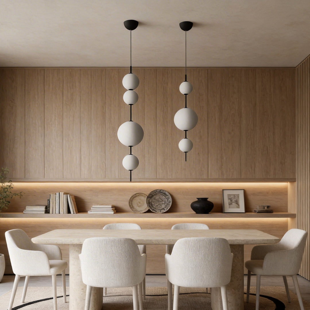 Multi ball pendant light with a modern design, hanging above a wooden dining table.