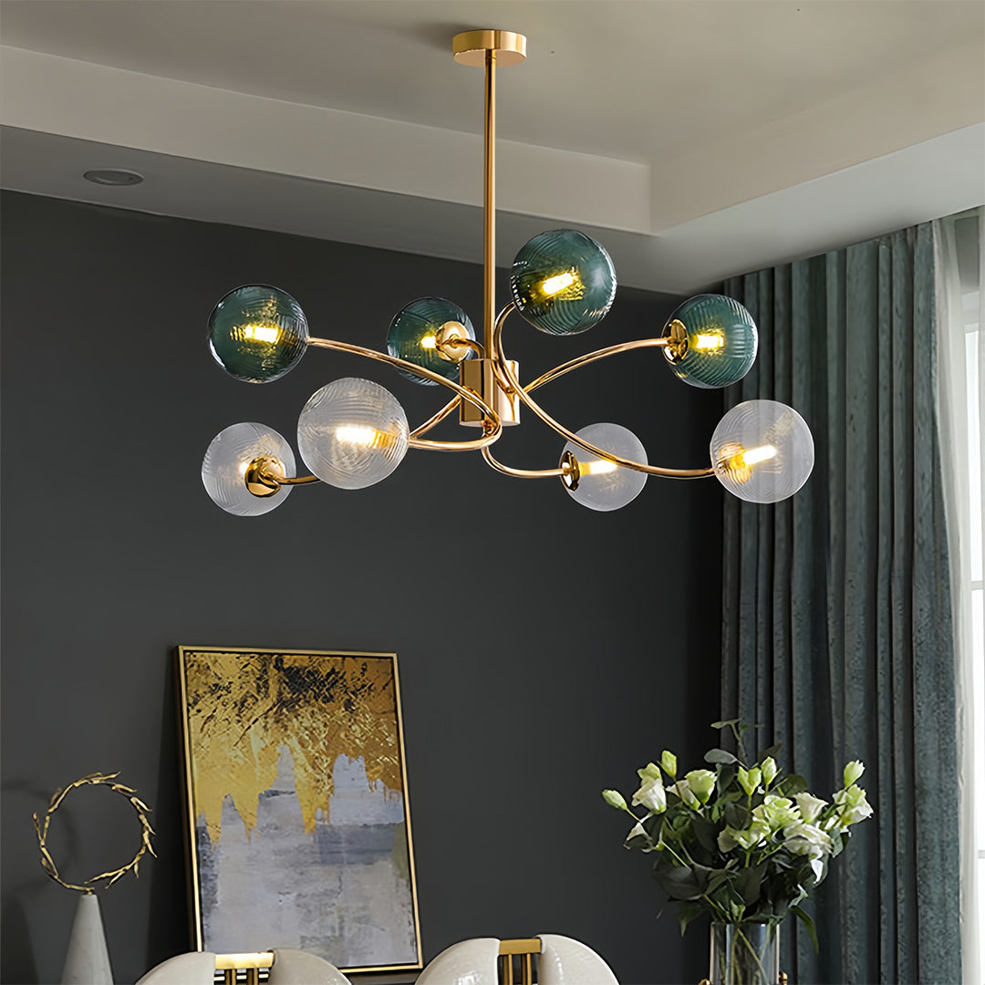 Multi-branch clear glass flush mount ceiling light with gold finish, providing sophisticated lighting to a dark-toned dining area.