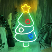 Multi-color holiday neon sign, like a Christmas tree, used alongside halloween neon lights for seasonal decor.