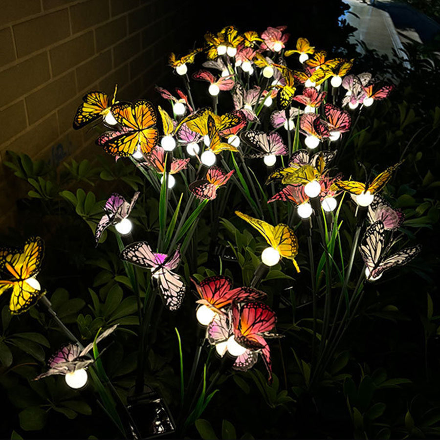 Multi-colored butterfly decorative lights creating ambient lighting in evening garden display