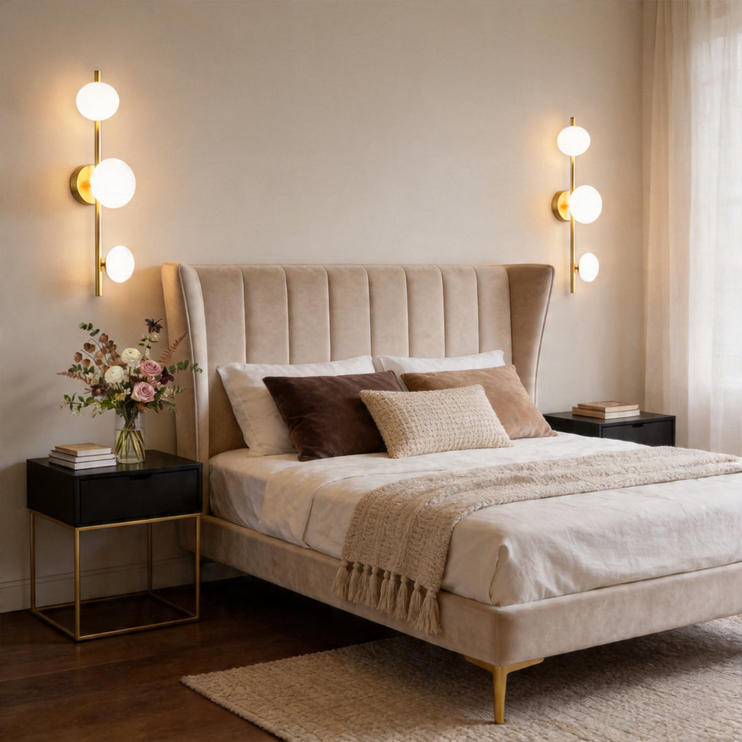 Multi light wall sconce placed beside a bed in a modern bedroom with soft lighting and elegant design.