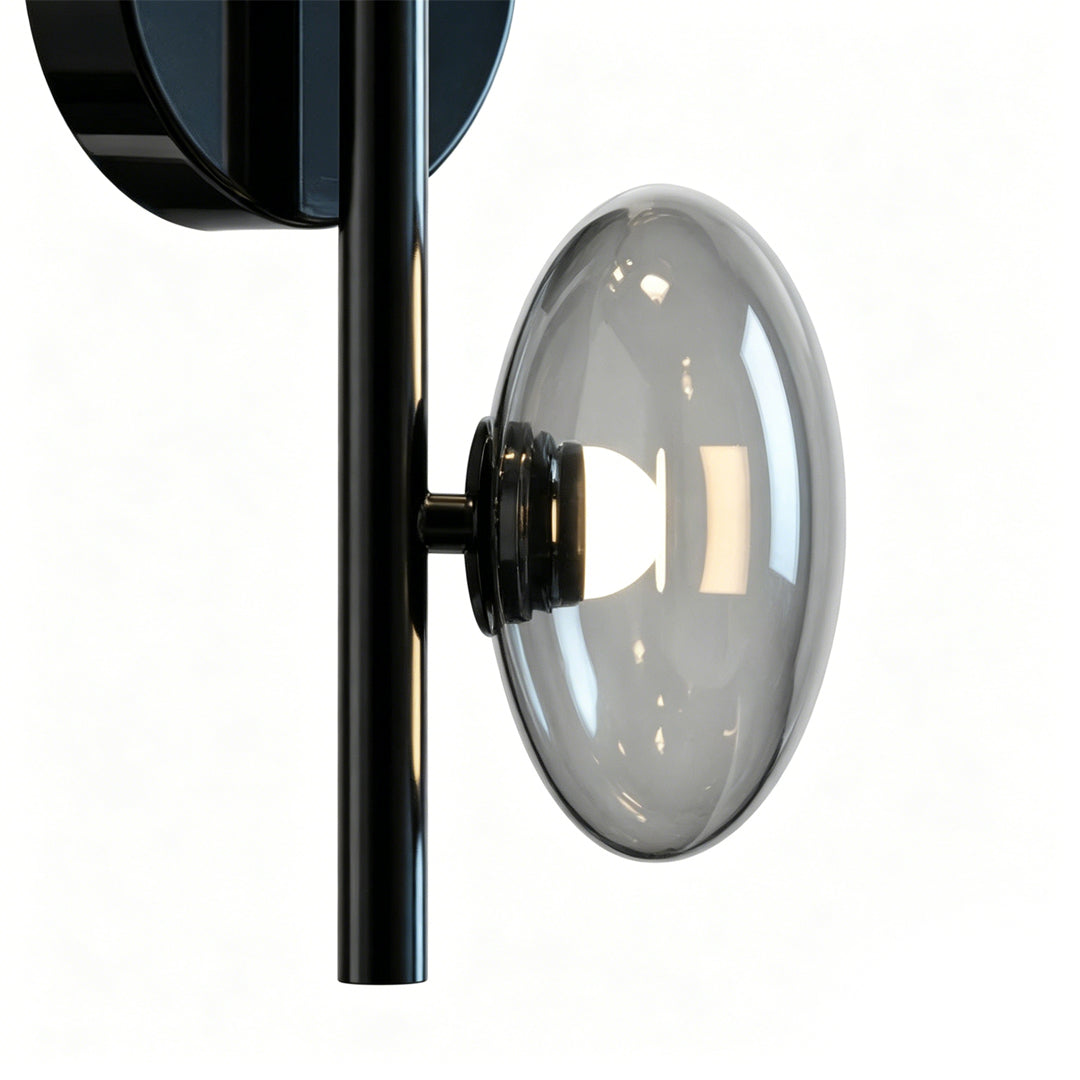Side view detail of multi light wall sconce showing layered glass discs and metal frame structure.