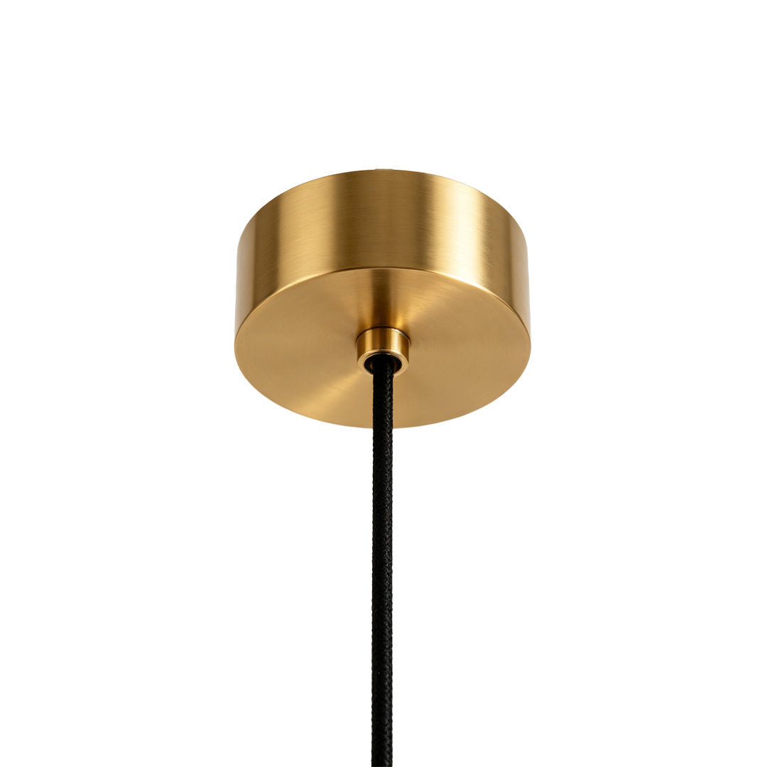 Ceiling canopy detail of multi pendant light fixture with gold finish.