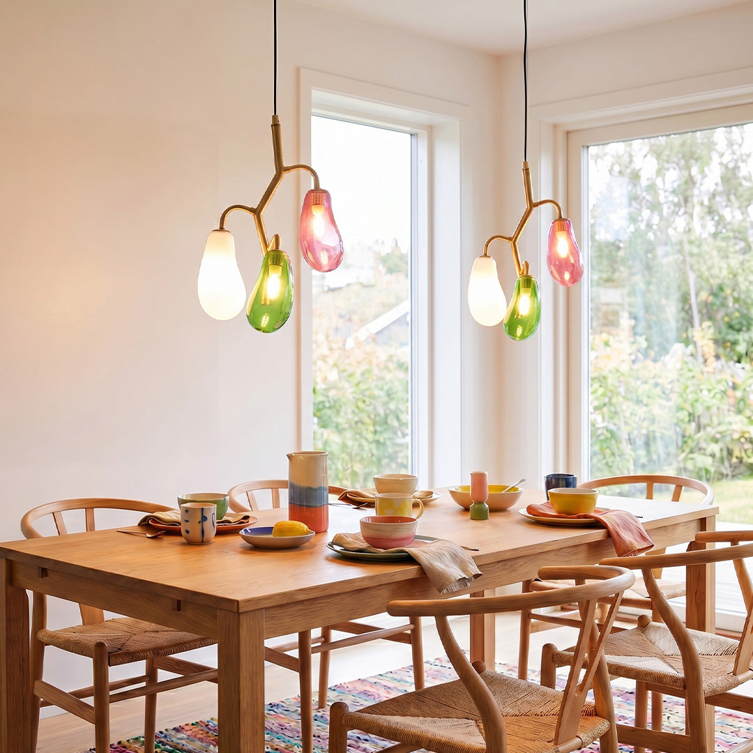 Colorful multi pendant light fixture illuminating a bright kitchen dining area.