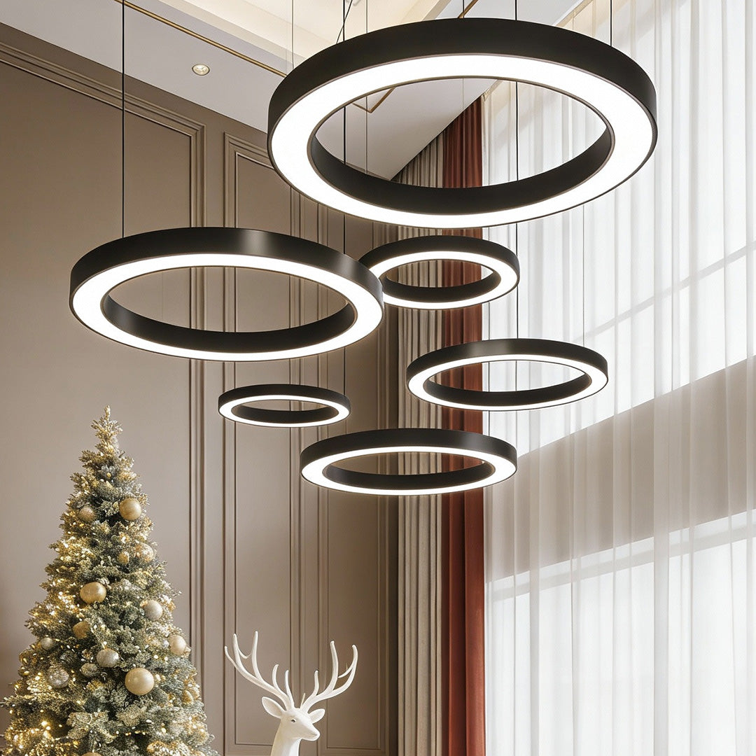 Multiple LED ring pendant lights hanging in a modern living room