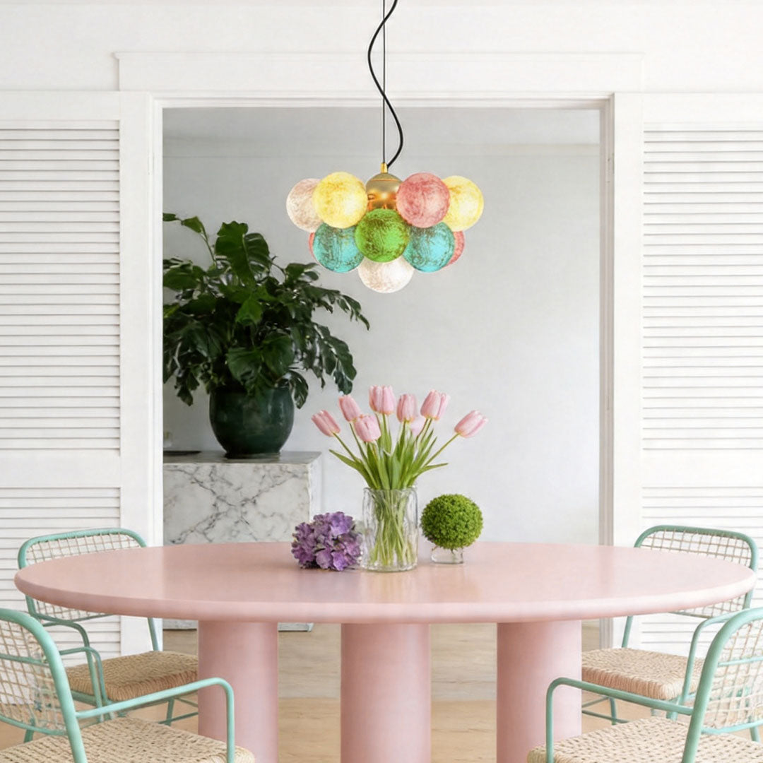 Multicolor stained glass chandelier displayed in a stylish dining area with pastel decor accents.
