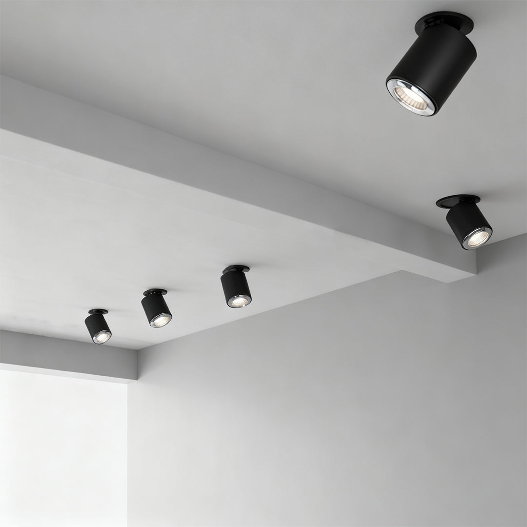 Multiple adjustable spotlights installed on white ceiling corner showing varied directional positioning