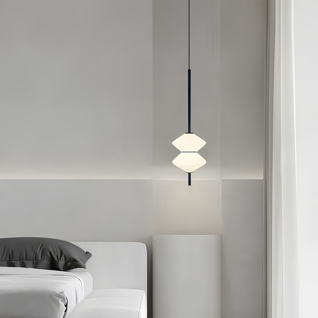 Modern bedside pendant light with multi-layered white shade in serene bedroom setting