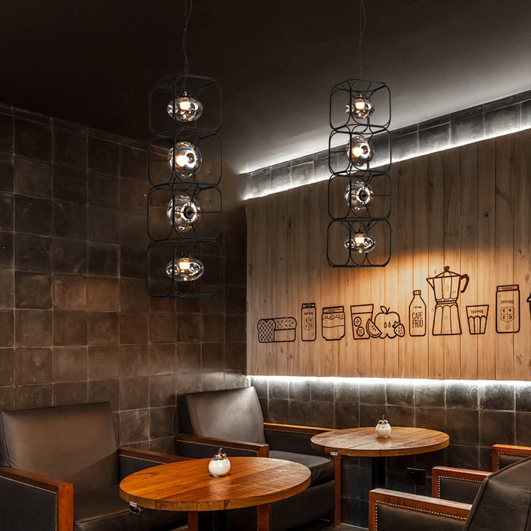 Multiple caged pendant light arrangement in restaurant setting creating atmospheric dining ambiance