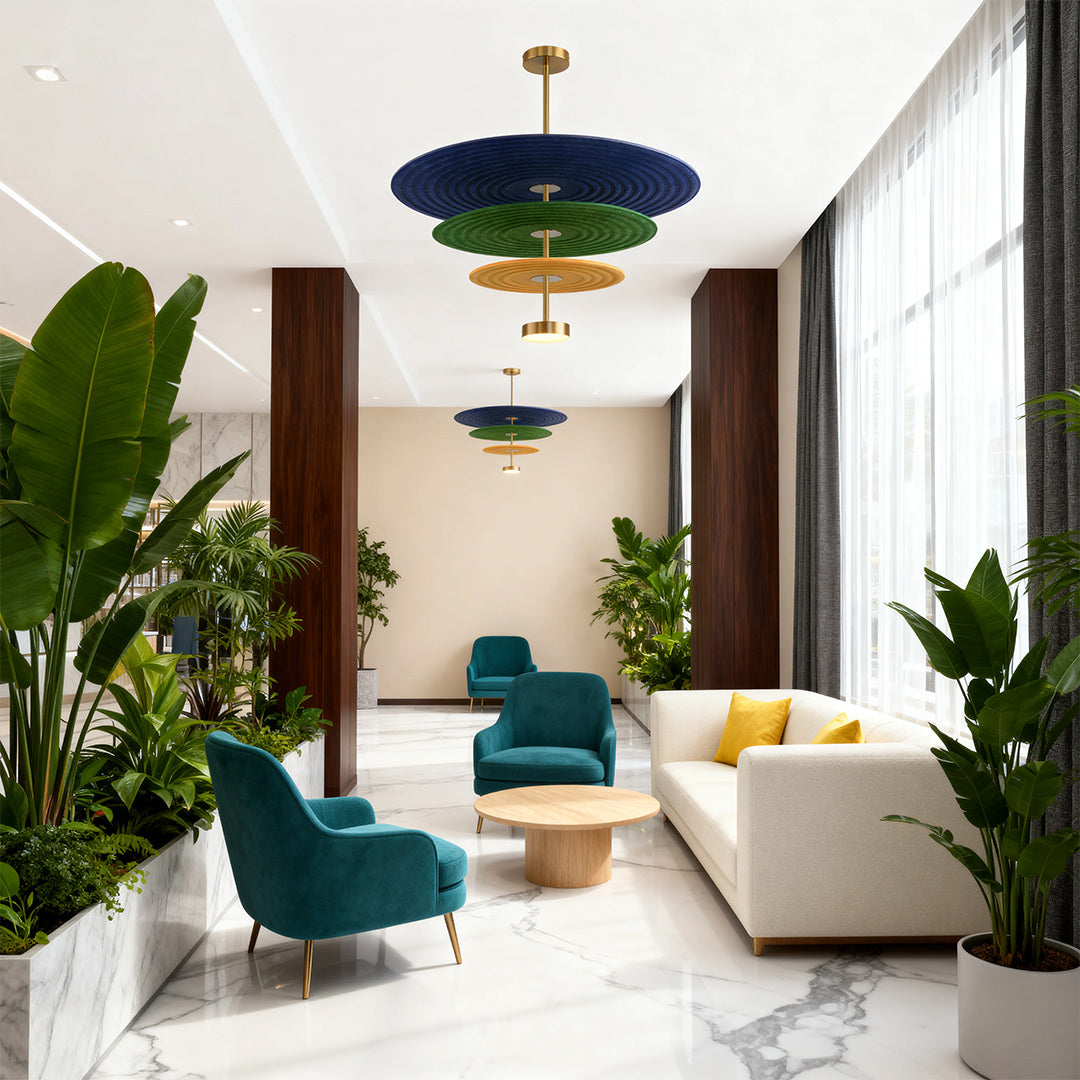 Multiple cascading blue and green 3 tier chandelier lights enhancing the sophisticated ambiance of a contemporary hotel lobby.