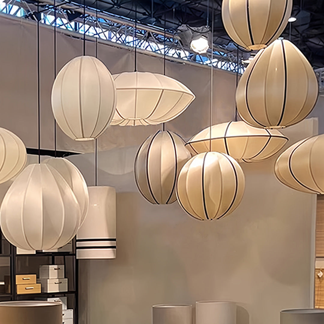 Multiple fabric shade pendant lights creating dramatic installation in modern commercial space
