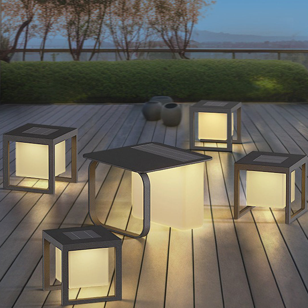 Multiple cubic outdoor lights arranged on wooden deck, handheld light collection creating ambient atmosphere