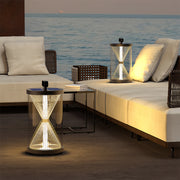 Multiple black outdoor lantern cap lights with house-shaped roofs lining a concrete fence and illuminated steps near a modern pool area.