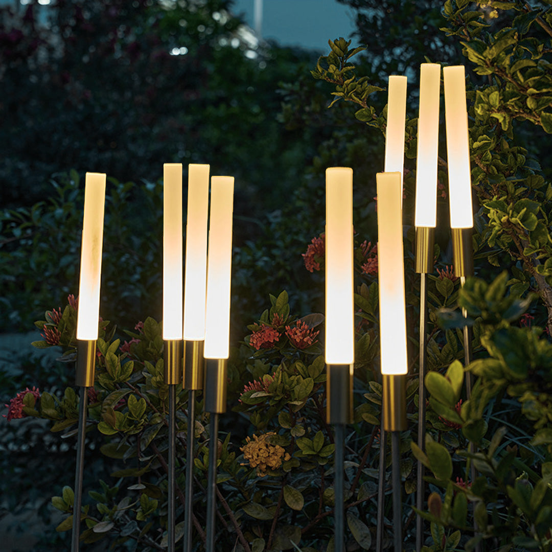 Multiple illuminated landscape spike lights creating stunning outdoor ambiance in contemporary garden landscape design