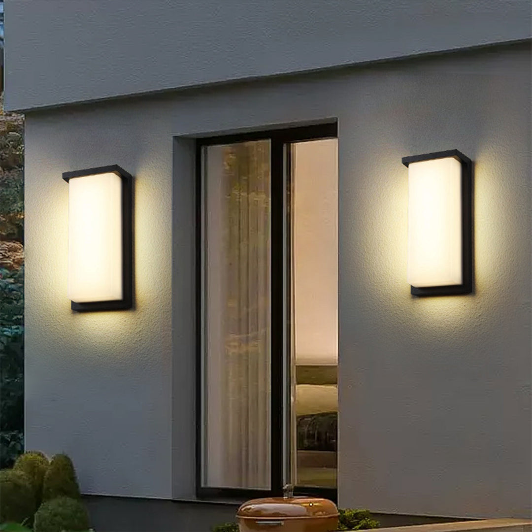 Multiple LED wall sconces providing uniform lighting on contemporary building facade entrance