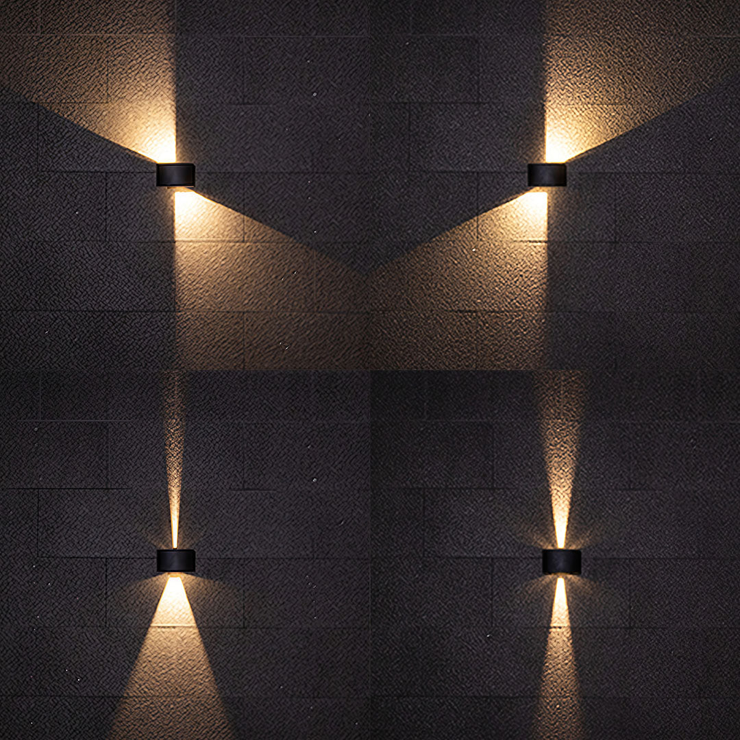 Multiple outdoor up down wall lights arranged vertically creating rhythmic lighting pattern