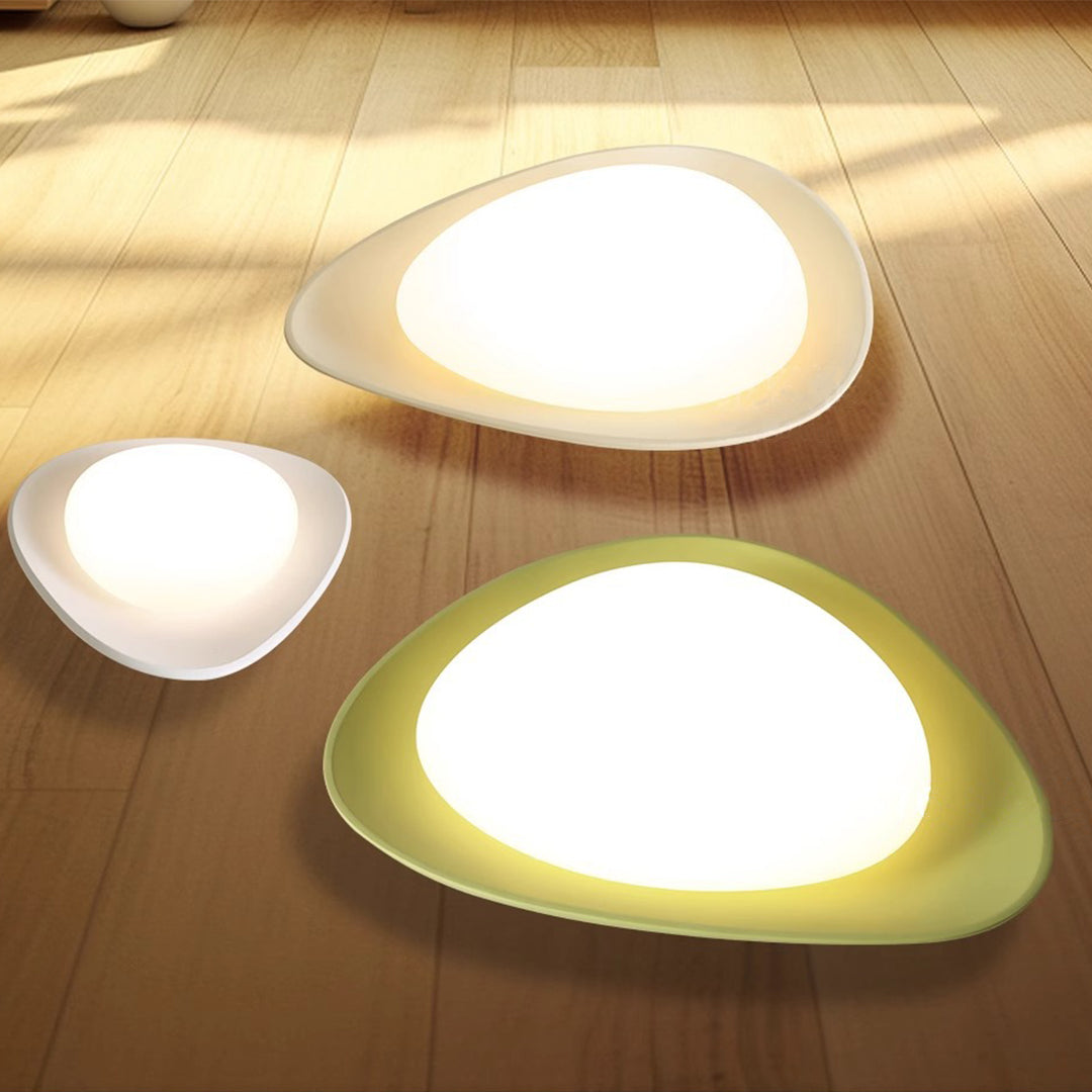 Multiple pebble ceiling lights creating layered ambient lighting on wooden ceiling surface