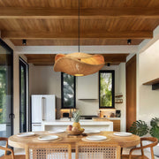 Multiple rattan pendant lights hanging above a dining table, providing unique and stylish lighting for the space.