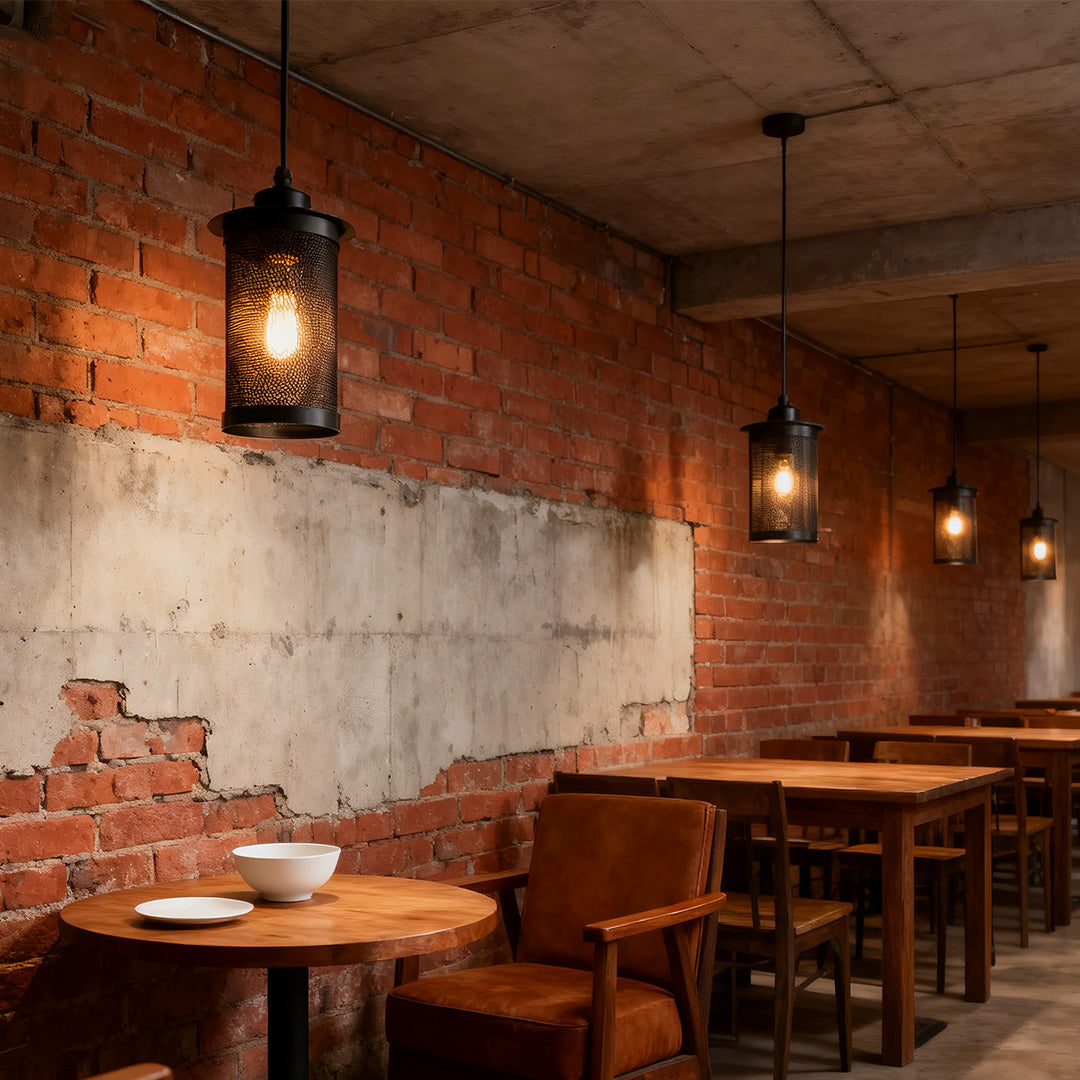 Multiple hanging retro industrial pendant lights creating atmospheric dining ambiance in a rustic cafe setting with round tables.