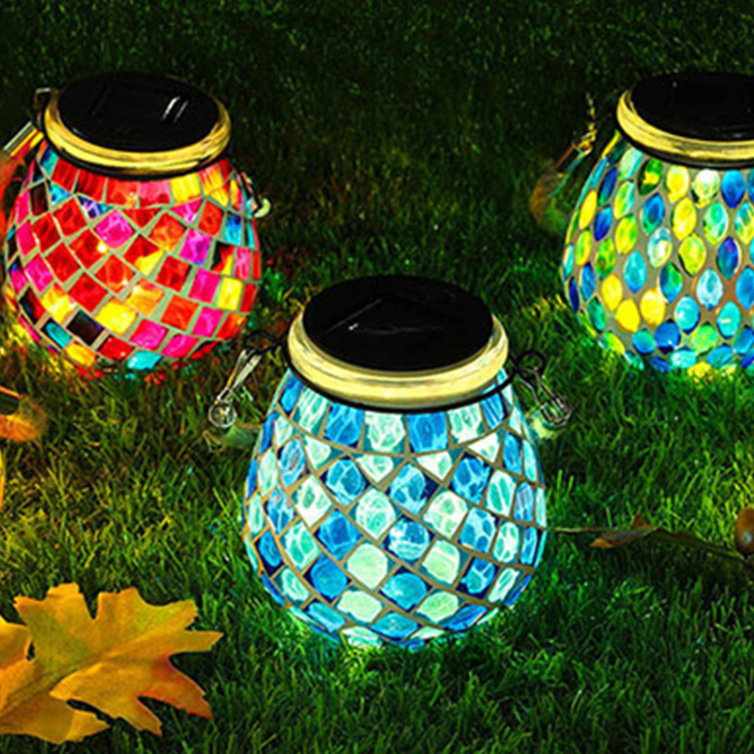 Multiple solar mosaic lights arranged in garden landscape creating magical evening atmosphere