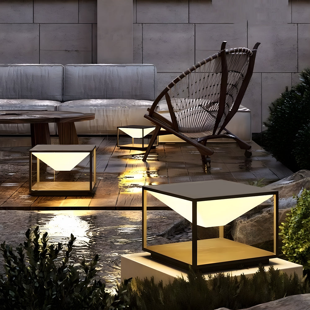 Multiple solar pillar lights creating sophisticated outdoor lighting design on modern concrete terrace with contemporary furniture