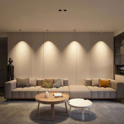 Multiple spotlights for house illuminating elegant living room with curtains and modern furniture