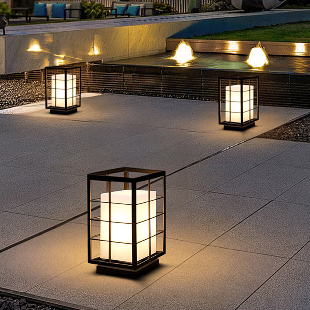Multiple square lanterns arranged on outdoor patio creating atmospheric evening lighting