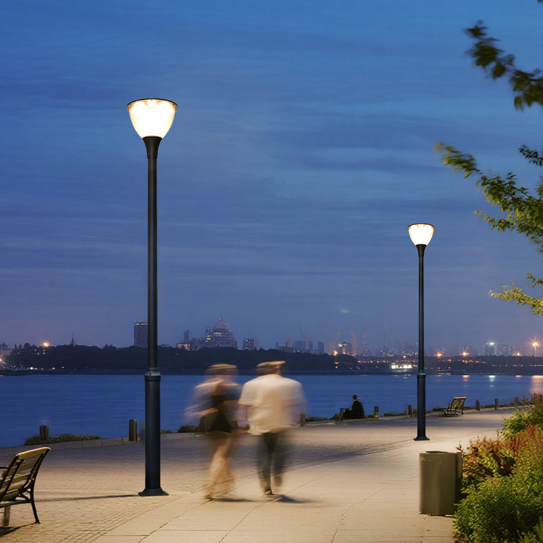 Multiple street lamps illuminating public park pathways with warm evening lighting