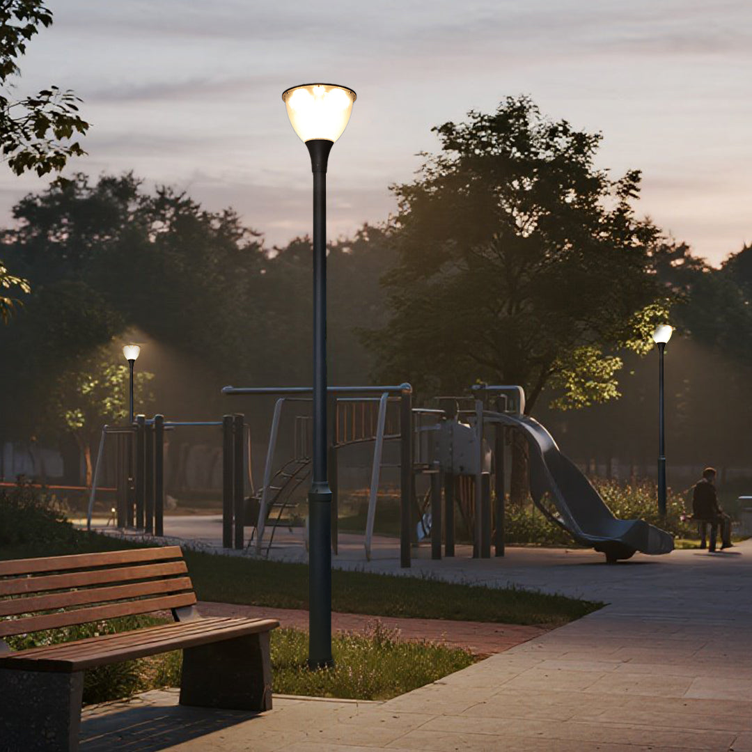 Multiple street lamps illuminating public park pathways with warm evening lighting
