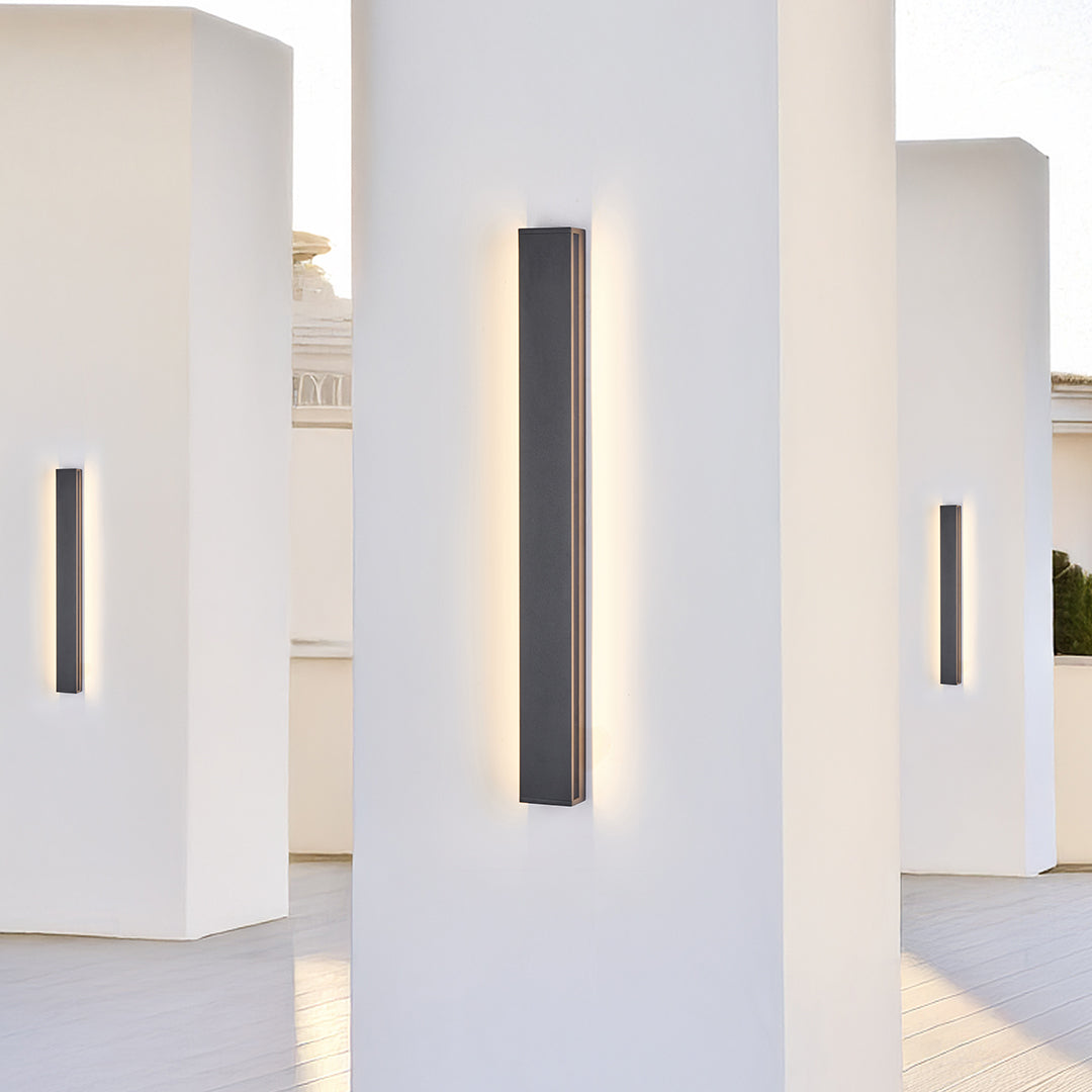 Multiple wall mounted linear lights creating dramatic lighting in contemporary art gallery space