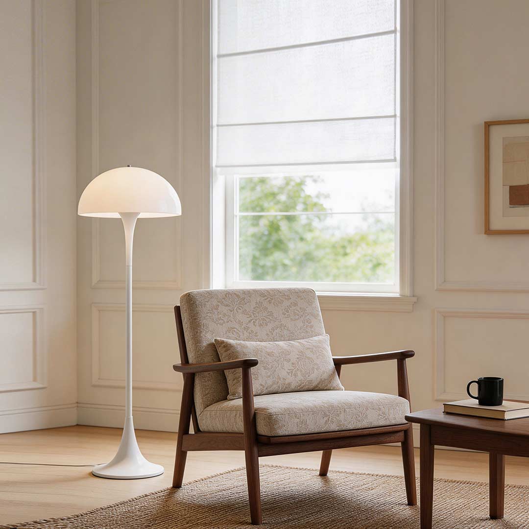 Mushroom floor lamp with a sleek design, illuminating a cozy corner with a wooden chair.