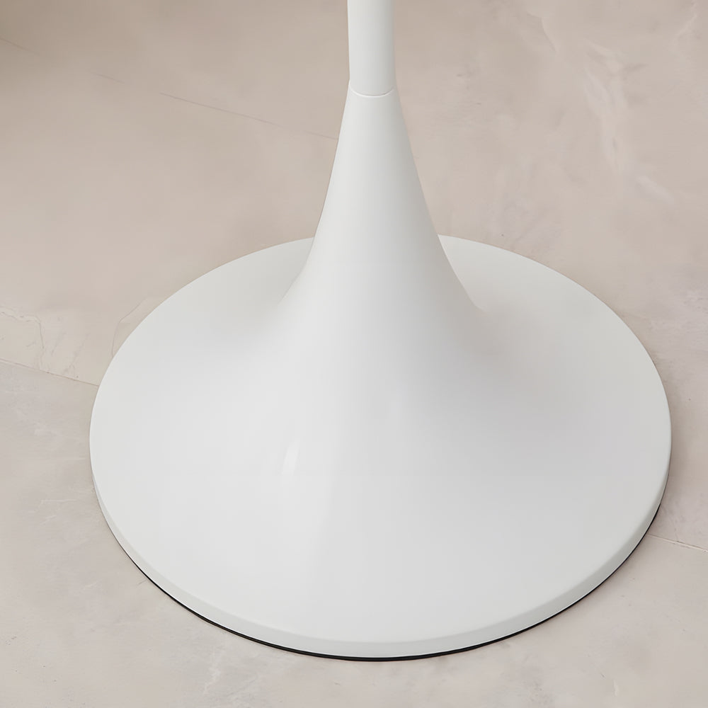 Mushroom floor lamp with a sleek white design, standing beside a white sofa.