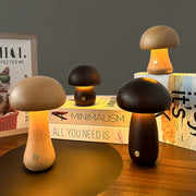 Collection of mushroom table lamps displayed on wooden surface with warm ambient lighting