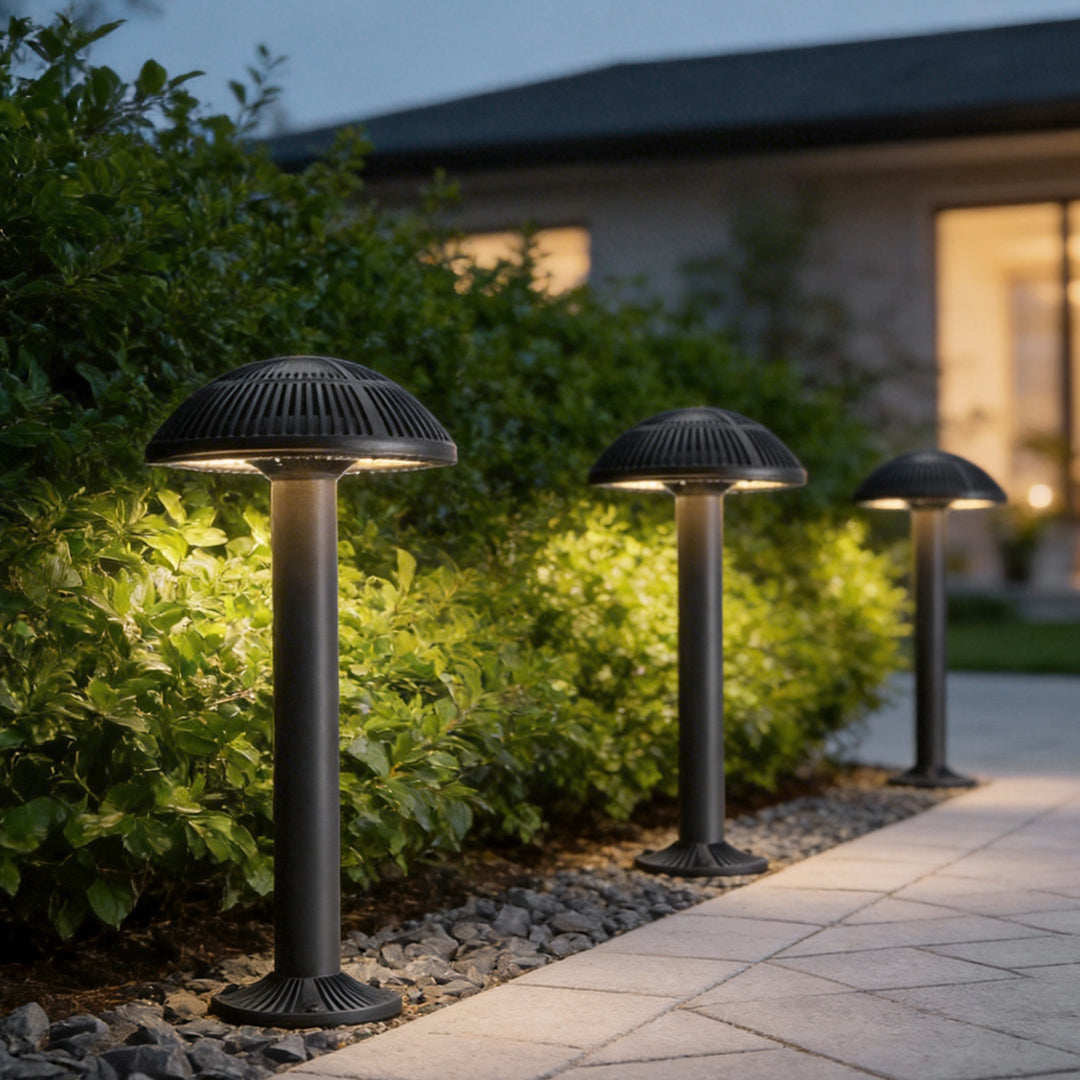 Mushroom landscape lights illuminating a garden pathway with a soft glow at dusk.
