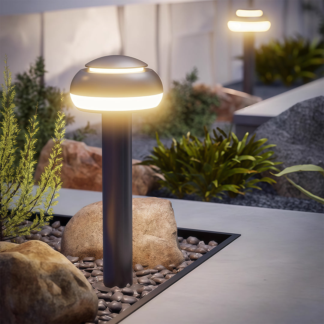 Mushroom path light installed in a garden, providing warm and inviting illumination.
