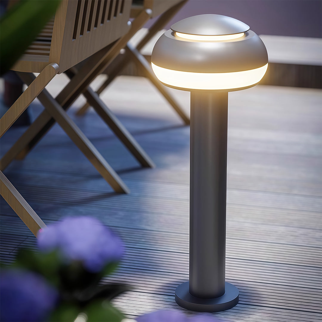 Mushroom path light near a seating area, offering stylish and functional lighting.