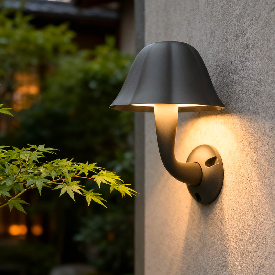 Close-up view of a mushroom wall light on a light-colored wall, adding soft outdoor accent lighting.