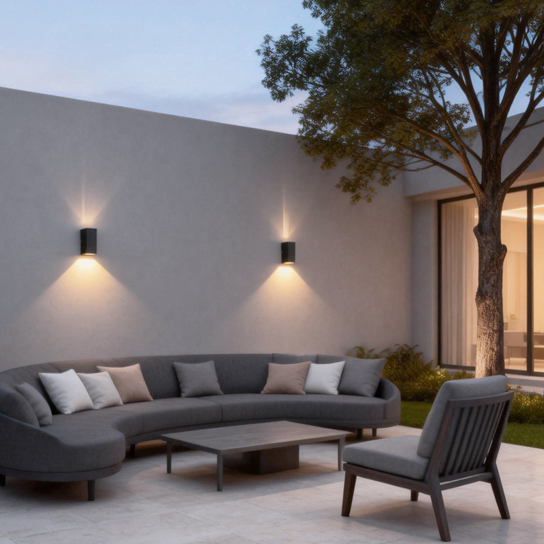 Narrow beam wall sconce mounted on a contemporary exterior wall, providing precise ambient lighting for an outdoor lounge space.