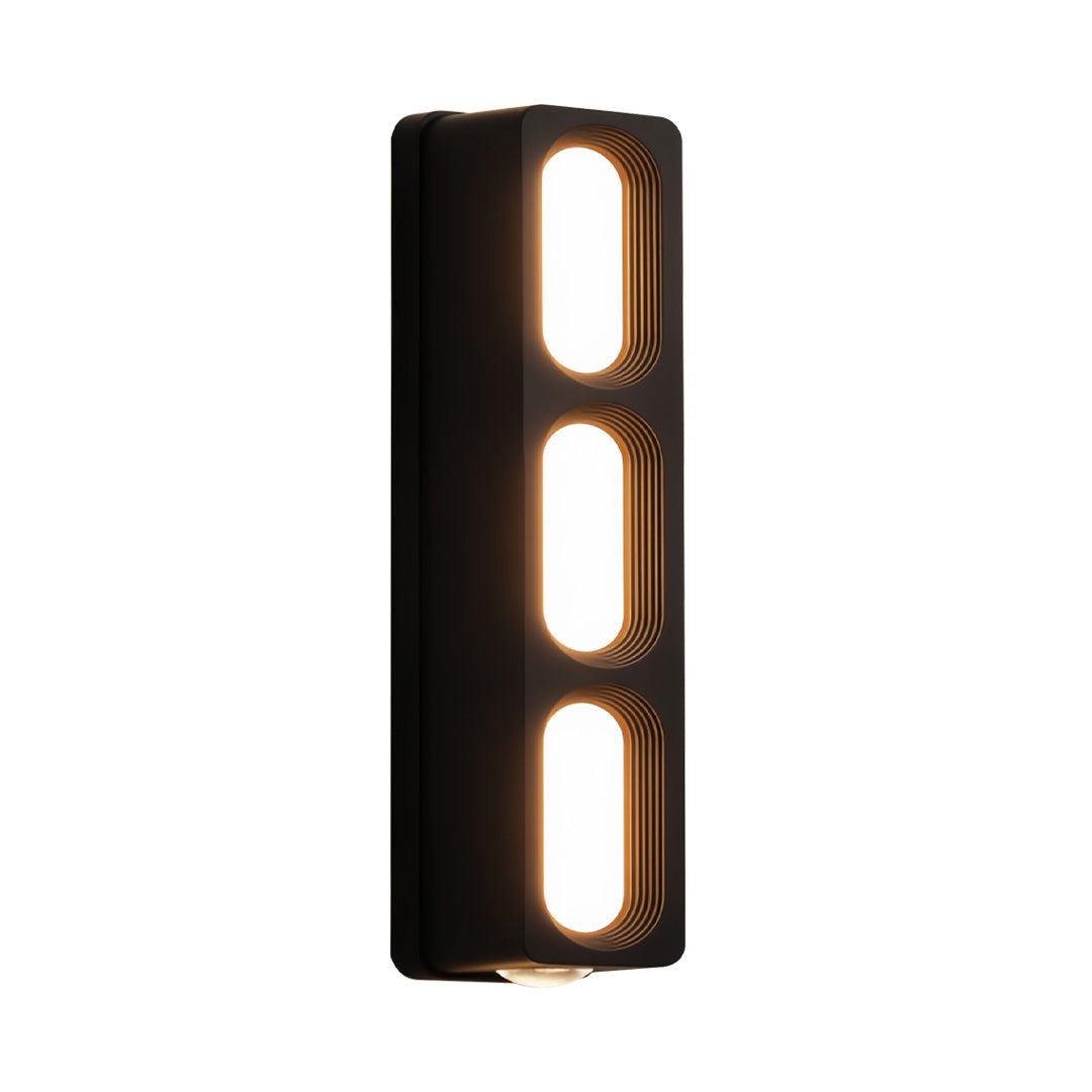 Compact narrow unique outdoor wall lighting fixture with two elongated openings and soft warm glow.