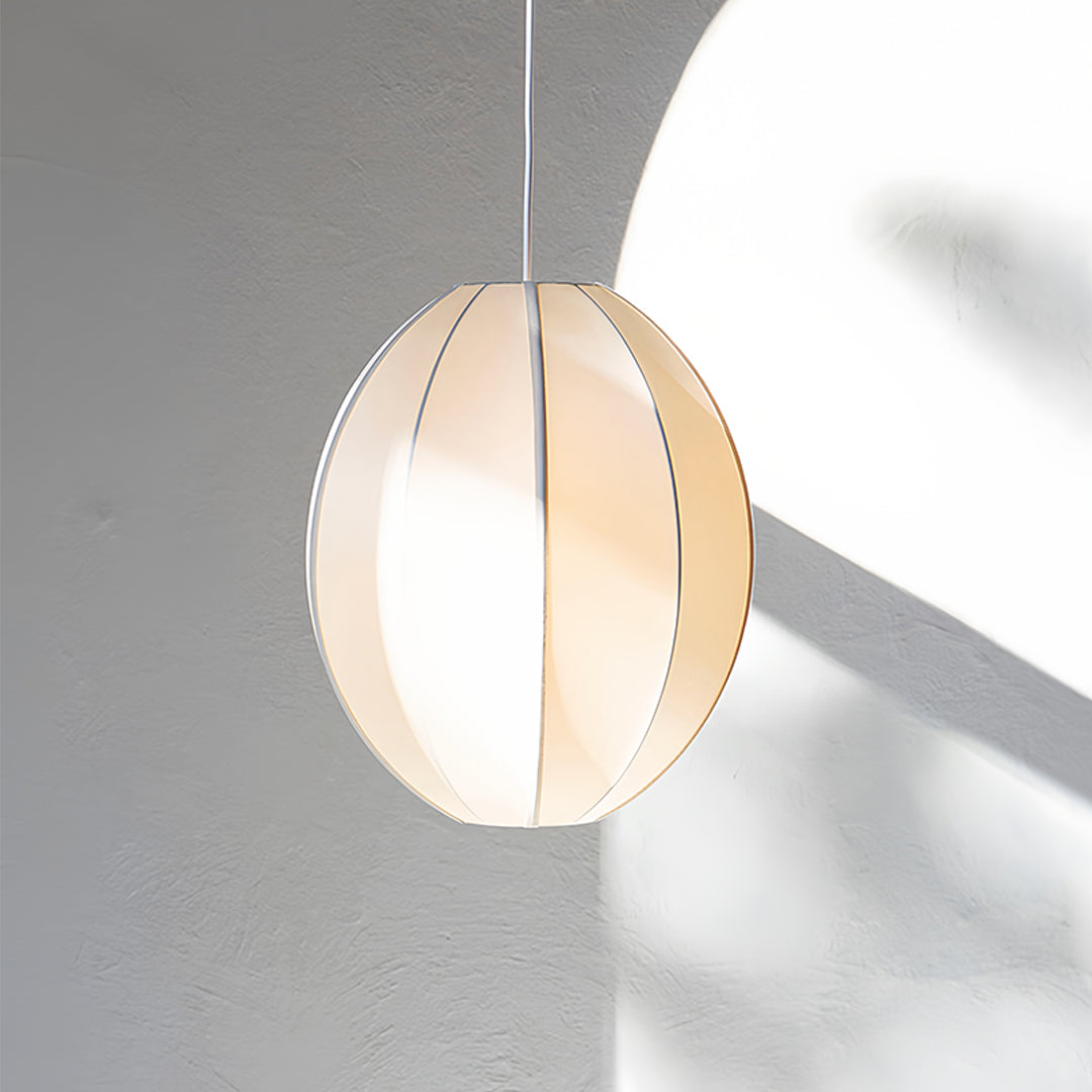 Natural fabric shade pendant light with warm beige tone and modern residential application