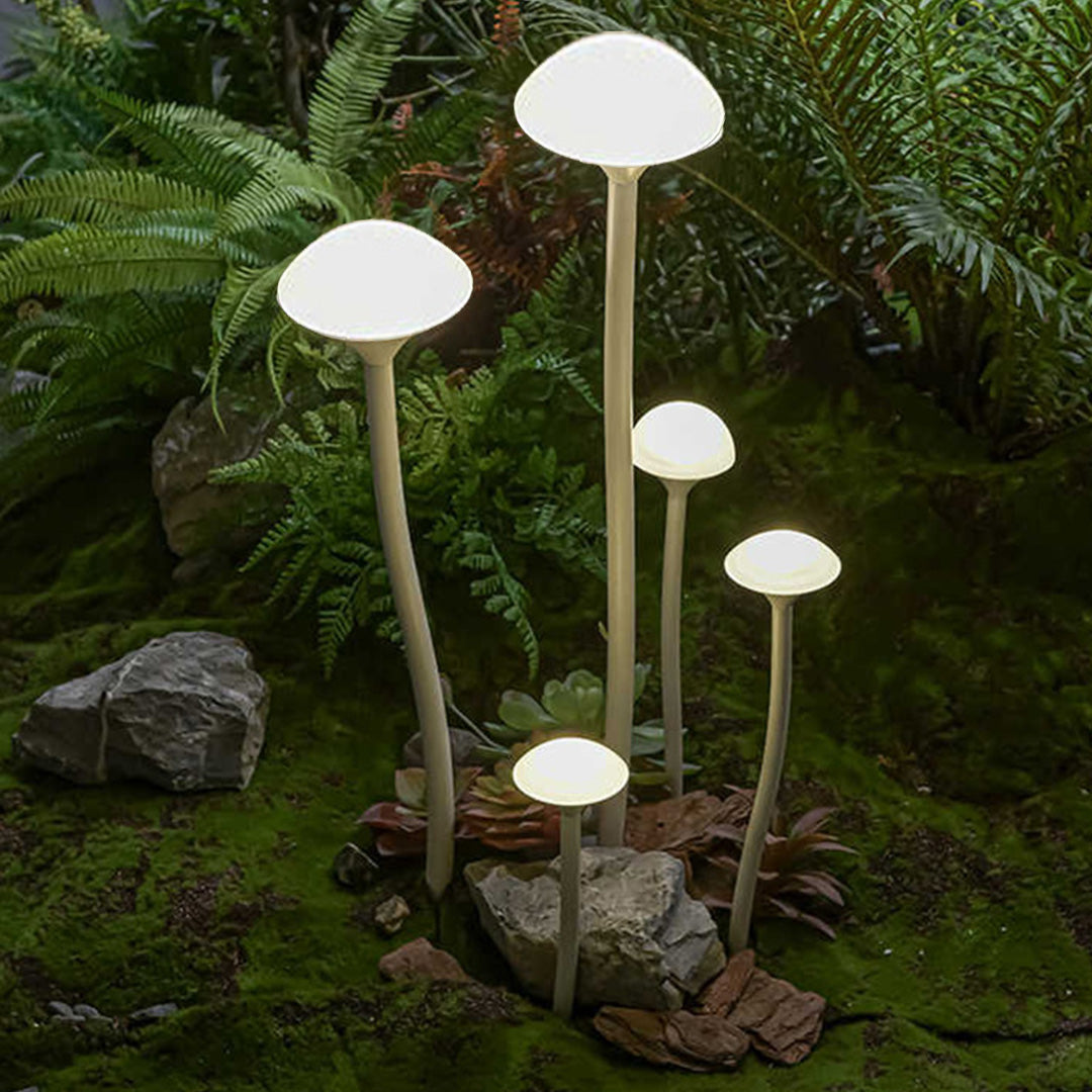 Natural garden setting with multiple mushroom-style garden lights landscape creating enchanting evening atmosphere among plants